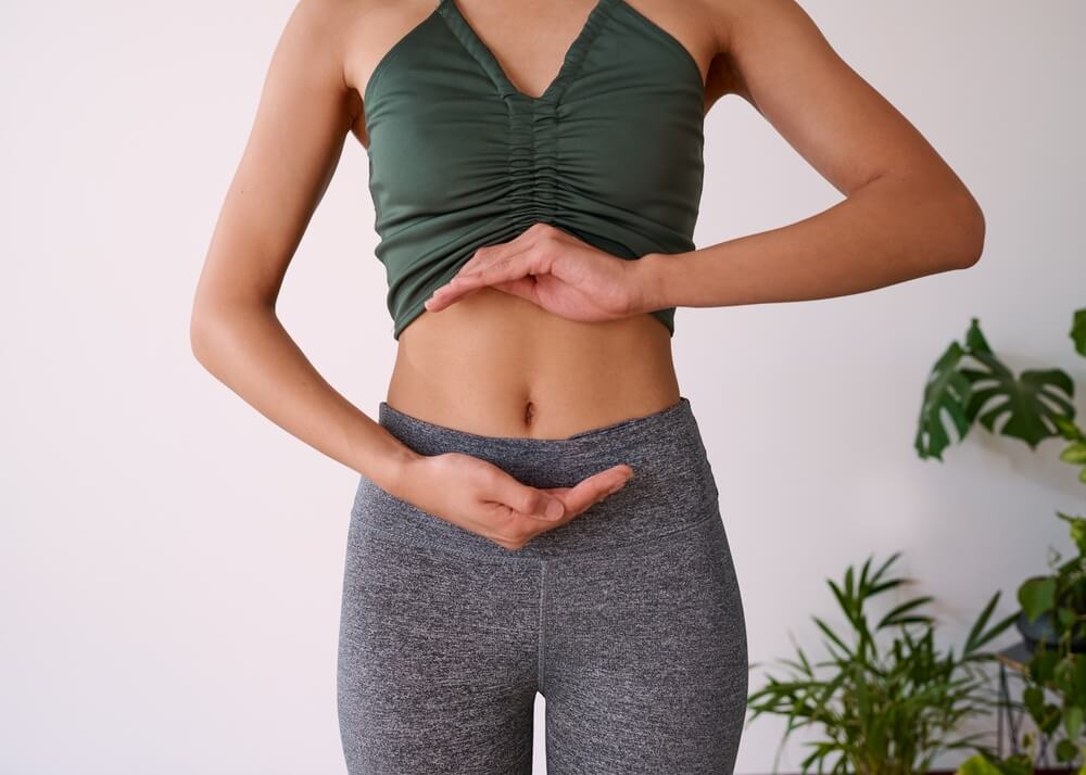 woman with her hands around her stomach
